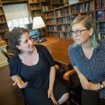 Inside the Dudley House library, Vanessa Zoltan, M.Div. '15 (left), proctor and member of the Board of Freshman Advisers, and Ariana Nedelman, M.Div. candidate '18, HDS staff member, discuss their new podcast "Harry Potter and the Sacred Text," which looks at the famous books as instructive and inspirational texts. 