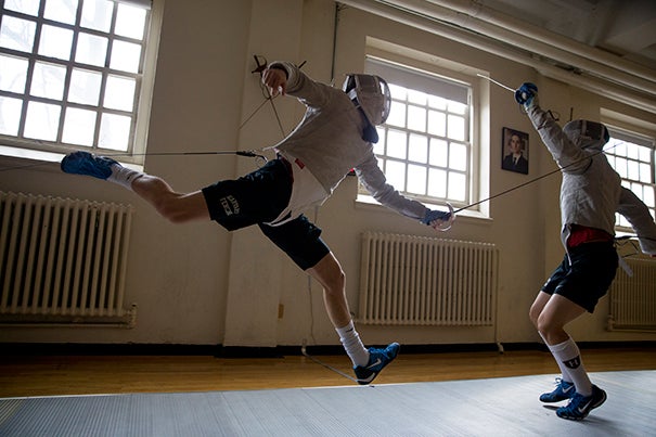 Harvard sophomore Eli Dershwitz (left) is poised for a medal run on Aug.10 as the youngest member of the U.S. Olympic men’s fencing team.