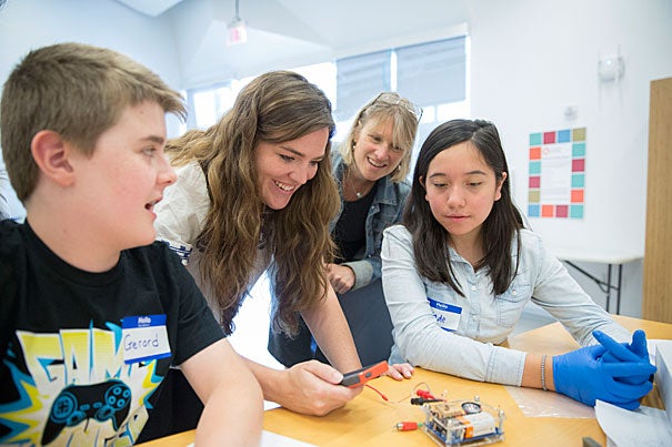 Gerard McGrath, (from left) rising 8th grader at the Boston Latin School, Katie Schmalkuche í16, Emily Henson, Program Manager, Harvard X for Allston, Susan Johnson, Manager of Teaching and Curriculum for the Education Portal and Jade Diaz, rising 8th grader, Saint Columbkille School in Brighton, learn about the basics of neuroscience and electricity in the brain using the curriculum of the Fundamentals of Neuroscience HarvardX course at the Ed Portal in Allston. Kris Snibbe/Harvard Staff Photographer