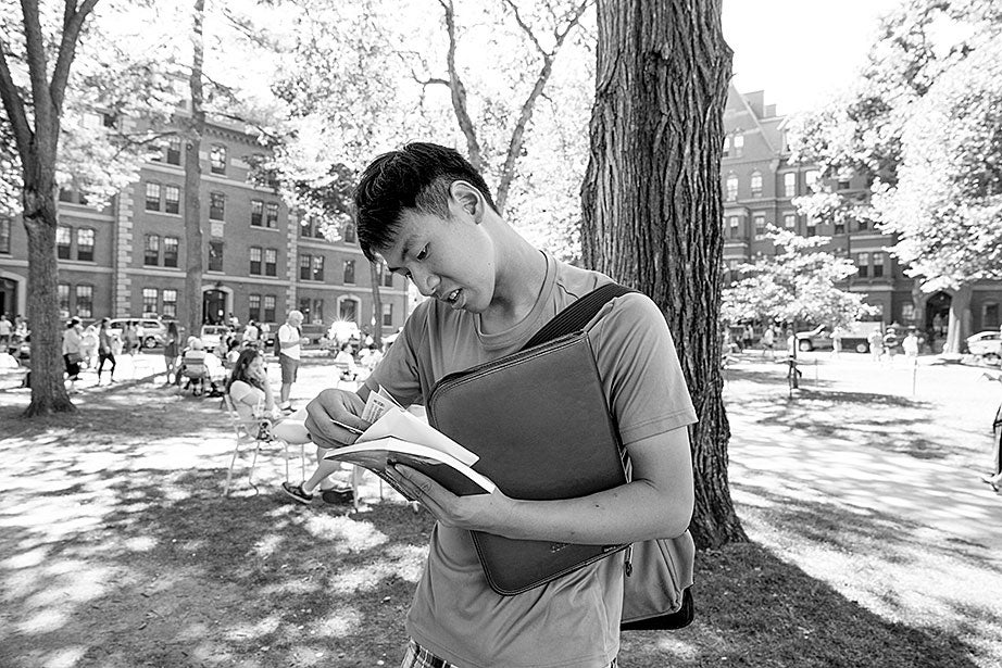 In Harvard Yard, Kevin checks his new Harvard ID, comparing it to the one from Boston Latin, and noting how much he has changed.