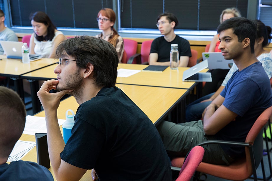 Alan Bidart '18 (left) listens intently during Virgilio Almeida’s class “The Internet: Governance and Power.” Jon Chase/Harvard Staff Photographer
