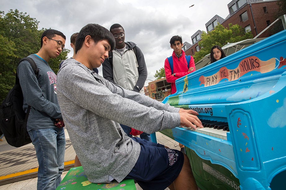 On the Science Center Plaza, master pianist George Hu '20 plays for his friends, Jonathan Suh '20 (from left), Michael Gaba '20, Arjun Mirani '20, and Elizabeth Yeoh-Wang '20, a joint Harvard/New England Conservatory concentrator. Harvard Common Spaces presented the piano as part of Street Pianos Boston 2016 in conjunction with Celebrity Series of Boston. Kris Snibbe/Harvard Staff Photographer