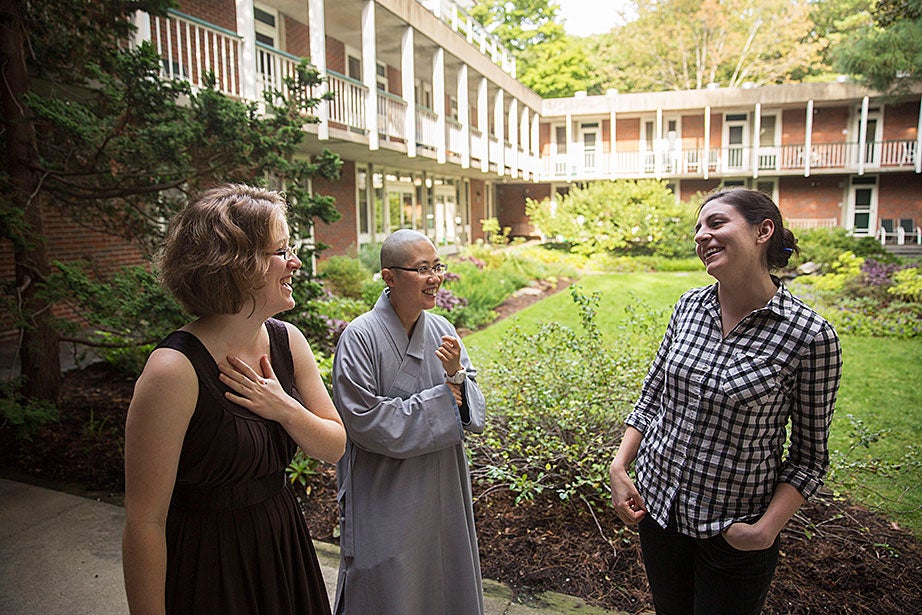 Center for the Study of World Religions residents (from left) Melissa Coles, a student at Harvard Divinity School; the Ven. Changshen Shi Wang, visiting assistant professor at HDS; and Sara Klingenstein, a student at the Graduate School of Arts and Sciences, chat in the center’s courtyard. “Residents are a microcosm of the larger community at HDS: a non-sectarian school of religious and theological studies that is home to a diverse community of scholars and practitioners,” Coles said.