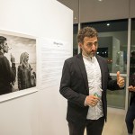 Maciek Nabrdalik (left) Nieman Fellow and documentary photographer, speaks about his exhibit, "Refugee Crisis," at the Crossings Gallery at the Harvard EdPortal. “I don’t treat it as artwork. It’s not a show that I would like you to ... compliment me for."