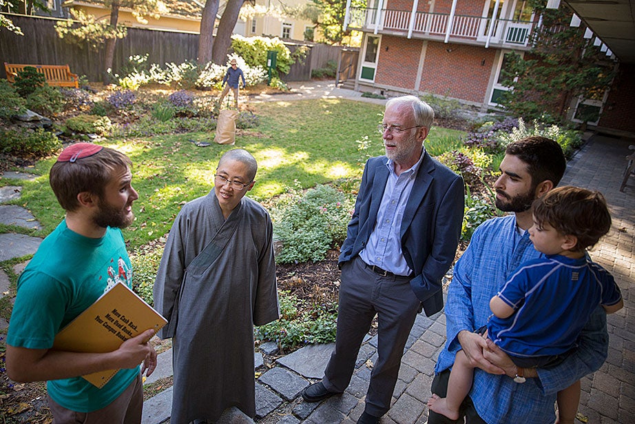 HDS student Daniel Kraft (from left), the Ven. Changshen Shi, CSWR Director Francis Clooney, Ph.D. candidate Seth Powell, and Powell’s 2-year-old son, Ruben, talk in the center’s courtyard. By facilitating connections with the larger Harvard community and beyond, the center convenes conversations about cutting-edge research.