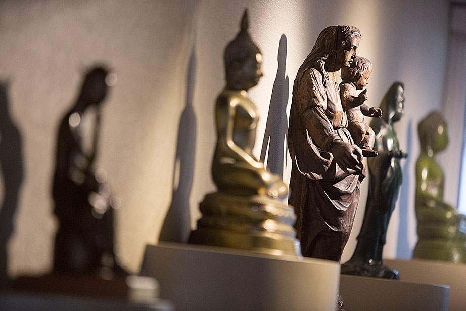 Christian and Buddhist statues are displayed together at the Center for the Study of World Religions. 