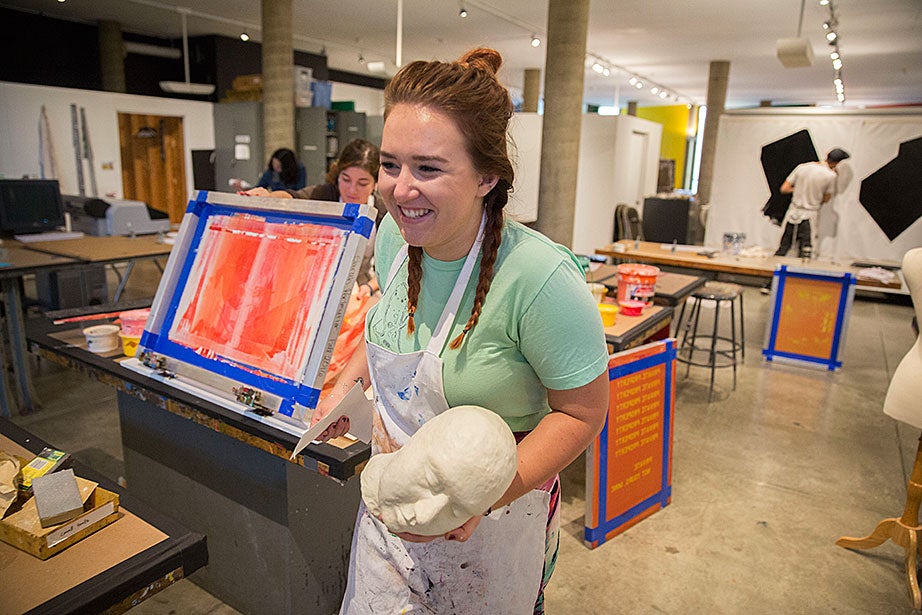 Alexa Oord '17 carries a plaster head for a project that incorporates the manipulation of found and original imagery in the fourth floor studios.