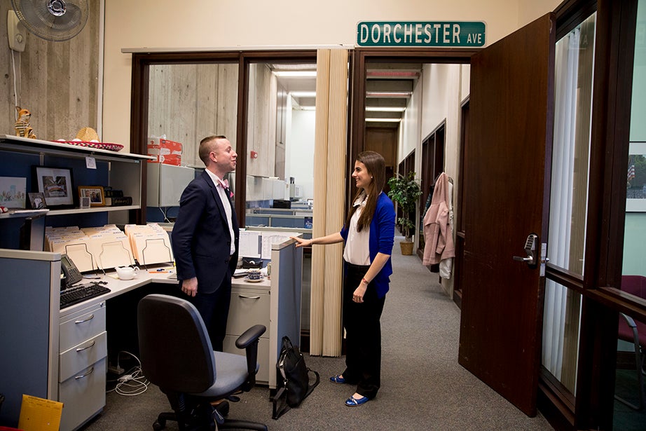 Lender and colleague Alex Zafris talk shop in their office space.