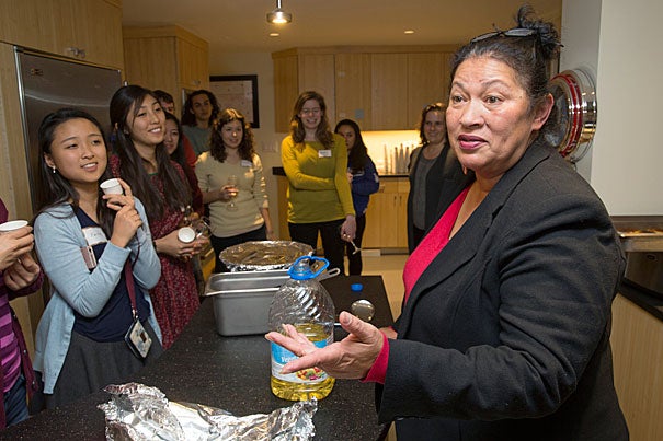 Faith Pak '19 (left) and other Pforzheimer House members listen as Wampanoag chef Sherry Pocknett explains how some of the ingredients used in traditional Native American cuisine were gathered and prepared.