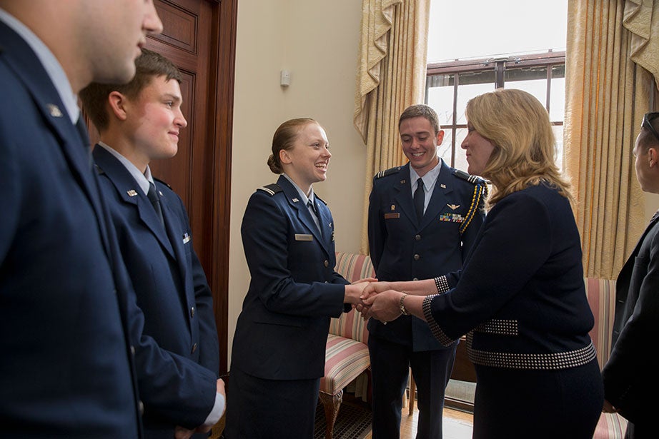 Deborah Lee James (right), the 23rd Secretary of the Air Force, shakes hands with Kira Headrick ’17 (left). Harvard President Drew Faust welcomed the return of the Air Force Reserve Officer Training Corps program to campus with a ceremonial signing and reception inside Loeb House on April 22, 2016. Also present are Ryan Comrie ’19 (from far left), Peter Hartnett ’19, and Alexander Farrow ’16. Rose Lincoln /Harvard Staff Photographer 