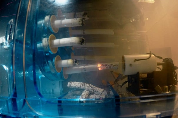 The cigarettes are lit and burned in a the rotatig unit of the smoking machine in intervals that mimick breathing patterns of real smokers. Credit Wyss Institute at Harvard University