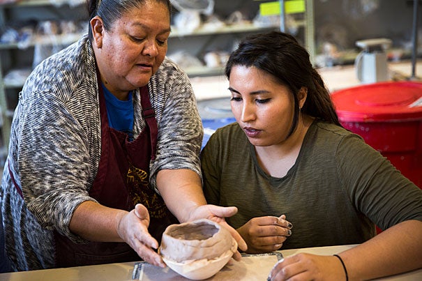 Two potters, Wilma Tosa and Aaron Tosa, from the Jemez Pueblo instruct students from Anthro 1010 taught by Matthew Liebmann in the making of traditional pottery. They teach techniques such as sgraffito and hand coiling. Wilma Tosa (left) demonstrates a coil building technique to Danielle Lucero, a graduate student from Harvard Graduate School of Education. Stephanie Mitchell/Harvard Staff Photographer