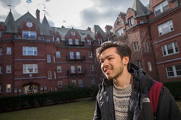 Sebastian Reyes '19, seen in the Adams House courtyard, reflects on the paradox of feeling at home both in Cambridge and his native Orange County, Calif. 