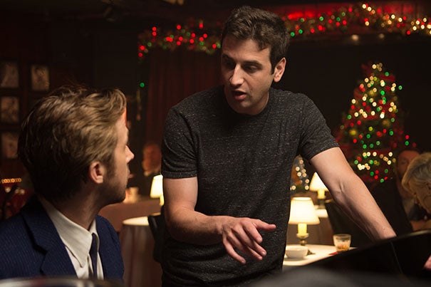 Composer Justin Hurwitz speaks with actor Ryan Gosling on the set of “La La Land.” Hurwitz credits his Harvard education with opening up “a lot of possibilities to me as a composer."
