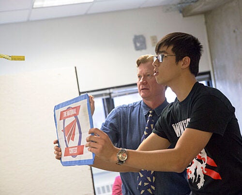 Albert Chien '19 (right) flies paper planes with John Collins, world record holder for flight distance of a paper airplane, during Collins' workshop that uses the surprisingly precise strategy of paper airplane folding to teach design engineering. 