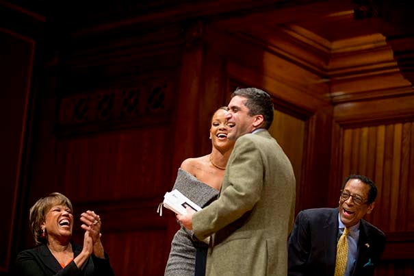 Pop star Rihianna (Robyn Rihanna Fenty) hugs Dean of Harvard College, Rakesh Khurana following his remarks. On left is Reverend Liz Walker, Mdiv '05 and and on right is Dr. S. Allen Counter, Director of the Harvard Foundation that awarded Rhianna the Humanitarian of the Year award at Sanders Theatre at Harvard University Rose Lincoln/Harvard Staff Photographer