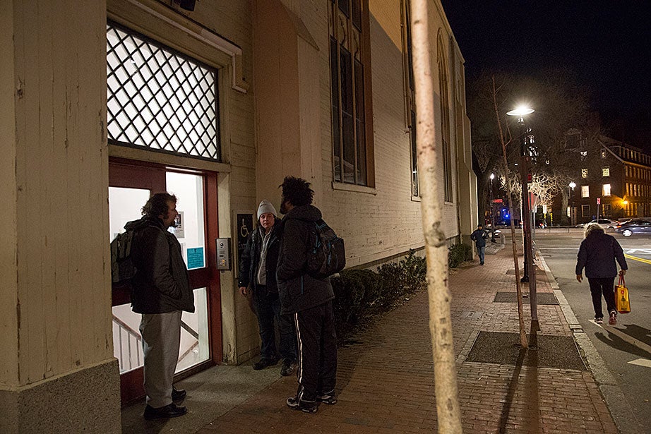 Guests outside 1 Church St. in Harvard Square wait for 7 p.m., when the Y2Y shelter opens and they can be admitted for dinner and the night. Guests can stay for up to 30 consecutive nights, then must re-enter a lottery for additional time. 