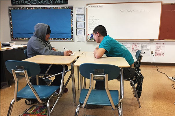 Li ’19 looks over homework with a student at Navajo Pine High School. Photo courtesy Will Li ’19