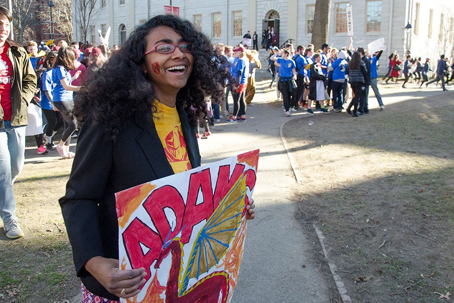 Eboni White ’17 from Adams shows support to her House by holding a sign. Photo by Silvia Mazzocchin