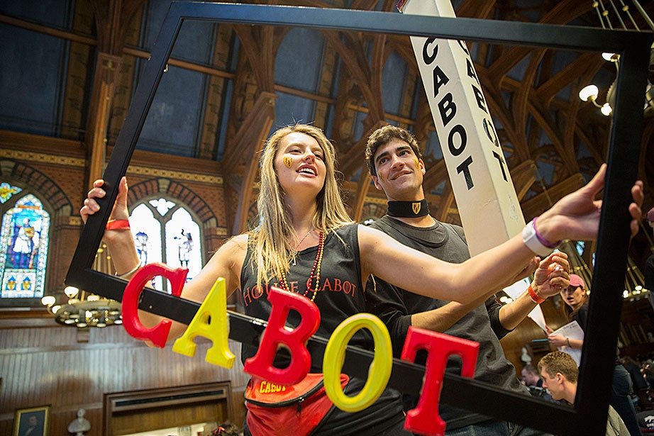 Sarah Chapman ’18 and Pietro Galeone ’17 boost Cabot House while students celebrate Housing Day inside Annenberg Hall. Kris Snibbe/Harvard Staff Photographer