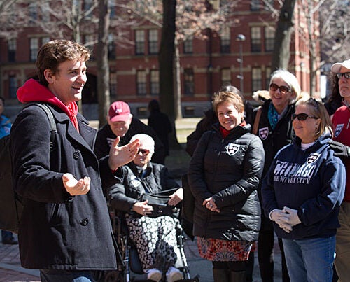 Bennett Capozzi '17 leads a campus tour in Harvard Yard as his mother (center) looks on admiringly. A dedicated altruist, he has volunteered at a Greek refugee camp and with Boston Foods, a group on campus working to combat food scarcity in metro Boston. 