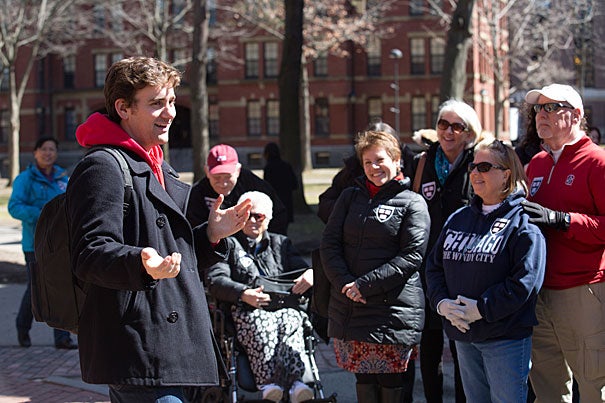 Bennett Capozzi '17 leads a campus tour in Harvard Yard as his mother (center) looks on admiringly. A dedicated altruist, he has volunteered at a Greek refugee camp and with Boston Foods, a group on campus working to combat food scarcity in metro Boston. 