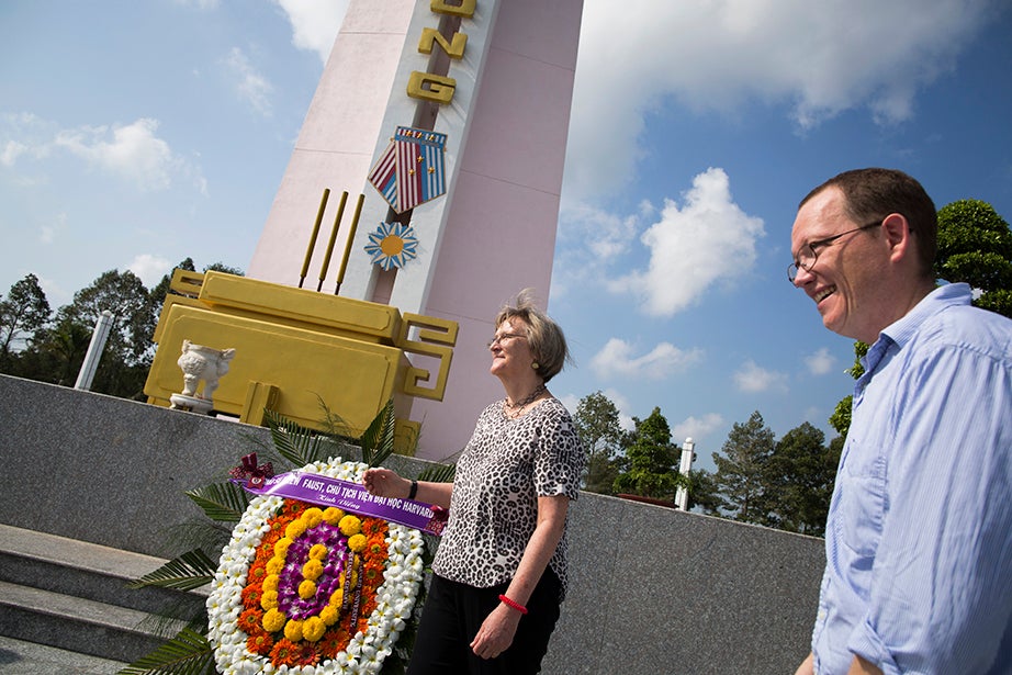 At the Ap Bac battlefield in Cai Lay, Tien Giang Province, Vietnam, Drew Faust (left) and Ben Wilkinson '98 lay a wreath at the public commemoration site.