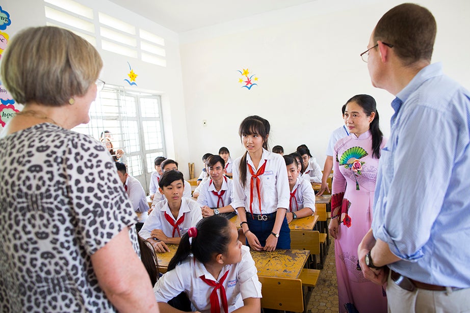 Drew Faust (from left) asks Trần Thị Ngọc Hân a question while teacher Vo Thi Mong Trinh looks on. Ben Wilkinson '98 helps translate.