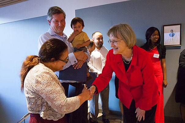New U.S. citizen Ana Umana (left) is congratulated by President Drew Faust. Lars Madsen, (center) became a U.S. citizen last year. Both he and Faust spoke during the Harvard Bridge Program's Annual Citizenship Celebration Dinner. "[R]emember how precious your citizenship really is, and use it," said Faust. "Take up not just its privileges, but also its responsibilities."