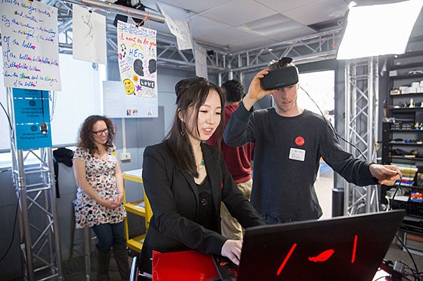 Divinity School student Ben Kurta (right) explores virtual reality with teaching fellow Bing Huang, Ph.D. '17, during the Derek Bok Center for Teaching and Learning’s first capstone showcase. 