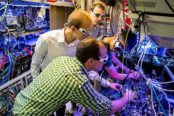 Physics Professor Markus Greiner (in back) and his team — Anton Mazurenko (from left), senior grad student, Daniel Greif, postdoc fellow, Geoffrey Ji, graduate student, and Christie Chiu (not shown) — have created an antiferromagnet, an exotic form of matter that can give important insights into how room temperature superconductors might be created.
