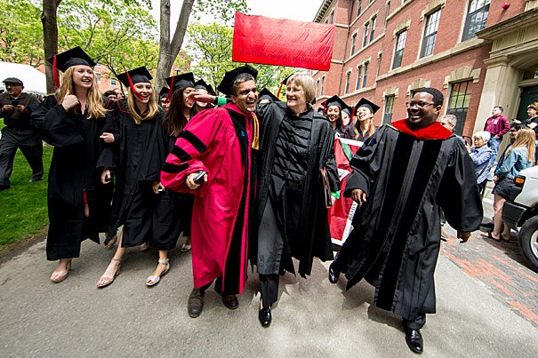 Late arrival Dean Rakesh Khurana (from left) greets Harvard President Drew Faust and 
the Rev. Professor Jonathan Walton as they lead graduating seniors through Harvard Yard to  the Baccalaureate Service in the Memorial Church.