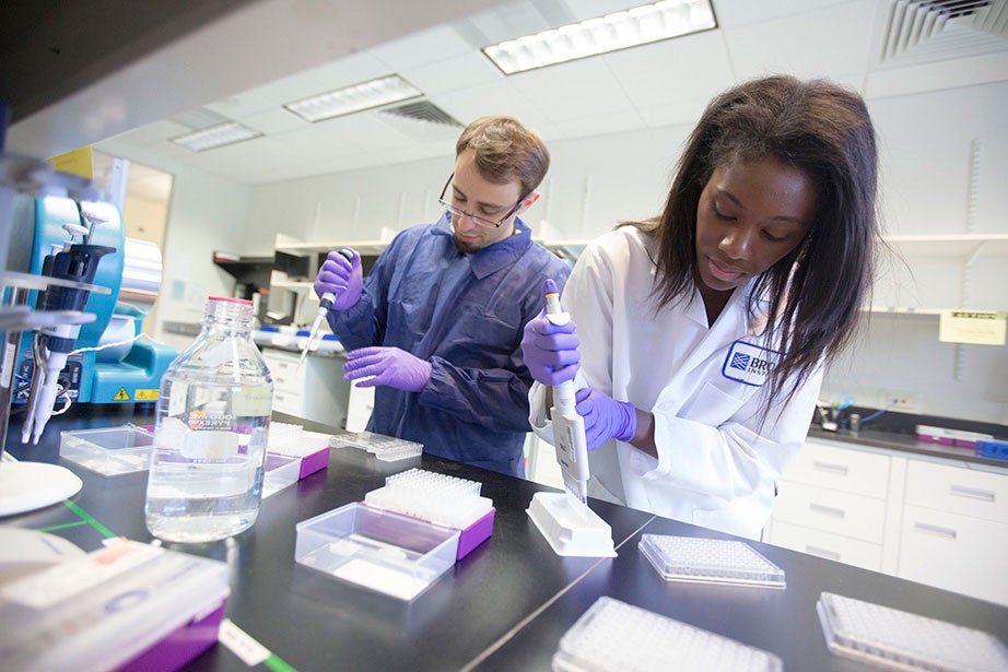 The Eli and Edythe L. Broad Institute of MIT and Harvard, which was endowed with a $400 million gift in 2008, is a biomedical and genomic research facility. Here, Cassandra Elie and Kevin Joseph ready whole-genome samples using sage pippin preparation. The Broad brings together faculty and scientists from across MIT, Harvard, and the Harvard-affiliated hospitals and beyond to tackle ambitious and important challenges in biomedicine. Kris Snibbe/Harvard Staff Photographer