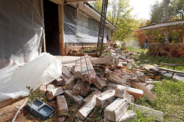 A man clears rubble in Sparks, Okla., following two earthquakes in 24 hours in November 2011. The area is home to thousands of fracking wells.