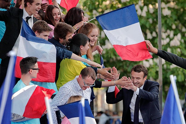 French President-elect Emmanuel Macron (right) greets supporters ahead of his landslide victory over far-right populist Marine Le Pen. Despite his margin of victory, Gunzberg Center senior affiliate Arthur Goldhammer predicts Macron will have little time to enjoy his political capital.
