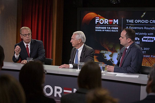 At the Harvard Chan School Forum on the nationwide opioid crisis, former governors Ted Strickland (from left) and Steven Beshear, the Menschel Senior Fellow, called for greater doctor cooperation and increased federal resources. Moderator and WGBH reporter Craig LeMoult led the discussion that was broadcast live on NPR.