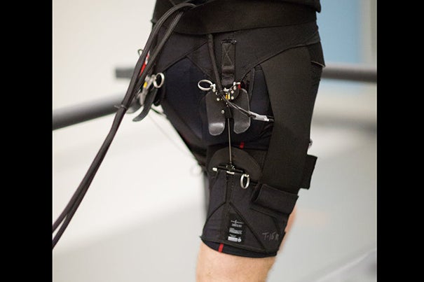 A system of actuation wires attached to the back of the exosuit provides assistive force to the hip joint during running.