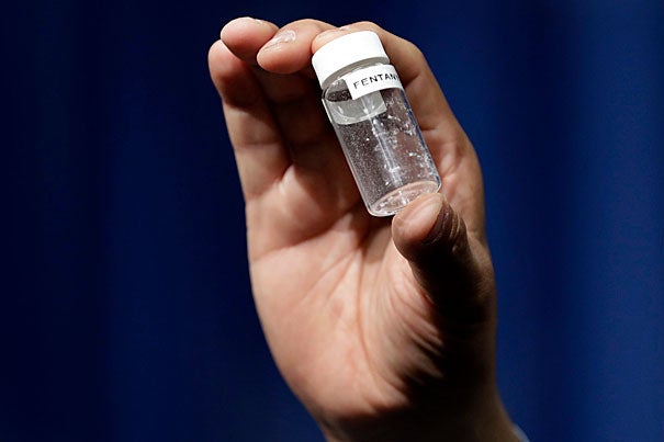 A reporter displays the volumetric equivalent of a fatal dose of fentanyl, a potent synthetic opioid that is being cut with heroin and posing greater risk to users and even first responders.