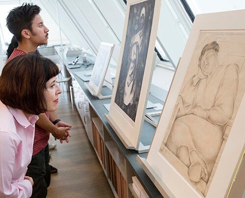 Viondette Lopez of Alexandria, Va. and Extension School student Hazard Ho study drawings by Diego Rivera at the Art Study Center of the Harvard Art Museums.