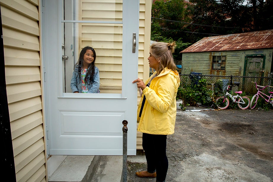 Aileen Navarrete walks 8-year-old Thao Nguyen home from the bus stop. “I don’t like the outside of my house,” Thao said. “I do,” replied Navarrete. “It’s the color of my coat.”