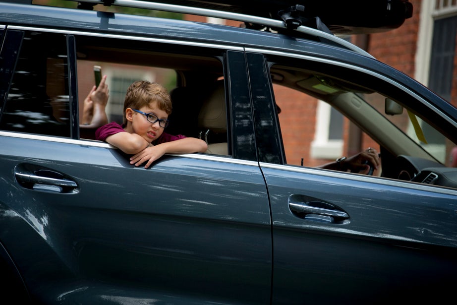 Eight-year-old Tomas Young pulls into Harvard Yard in the family car with his brother, incoming freshman Fernando Young. Rose Lincoln/Harvard Staff Photographer