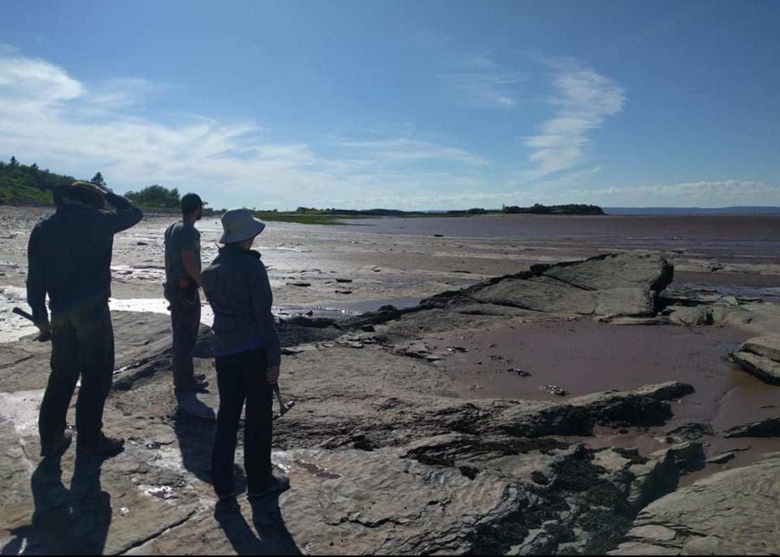 Stephanie Pierce, Chris Capobianco, and Blake Dickson survey the Bay of Fundy at Blue Beach, Nova Scotia. 