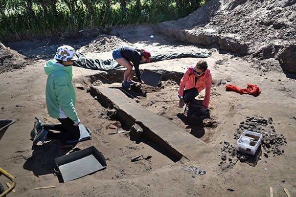 Harvard students Jessica Ding ’19 (from left), Andie Turner ’20, and Maile Sapp ’17 work at the dig site on the Danish island of Samsø as part of an immersive summer program on the Vikings