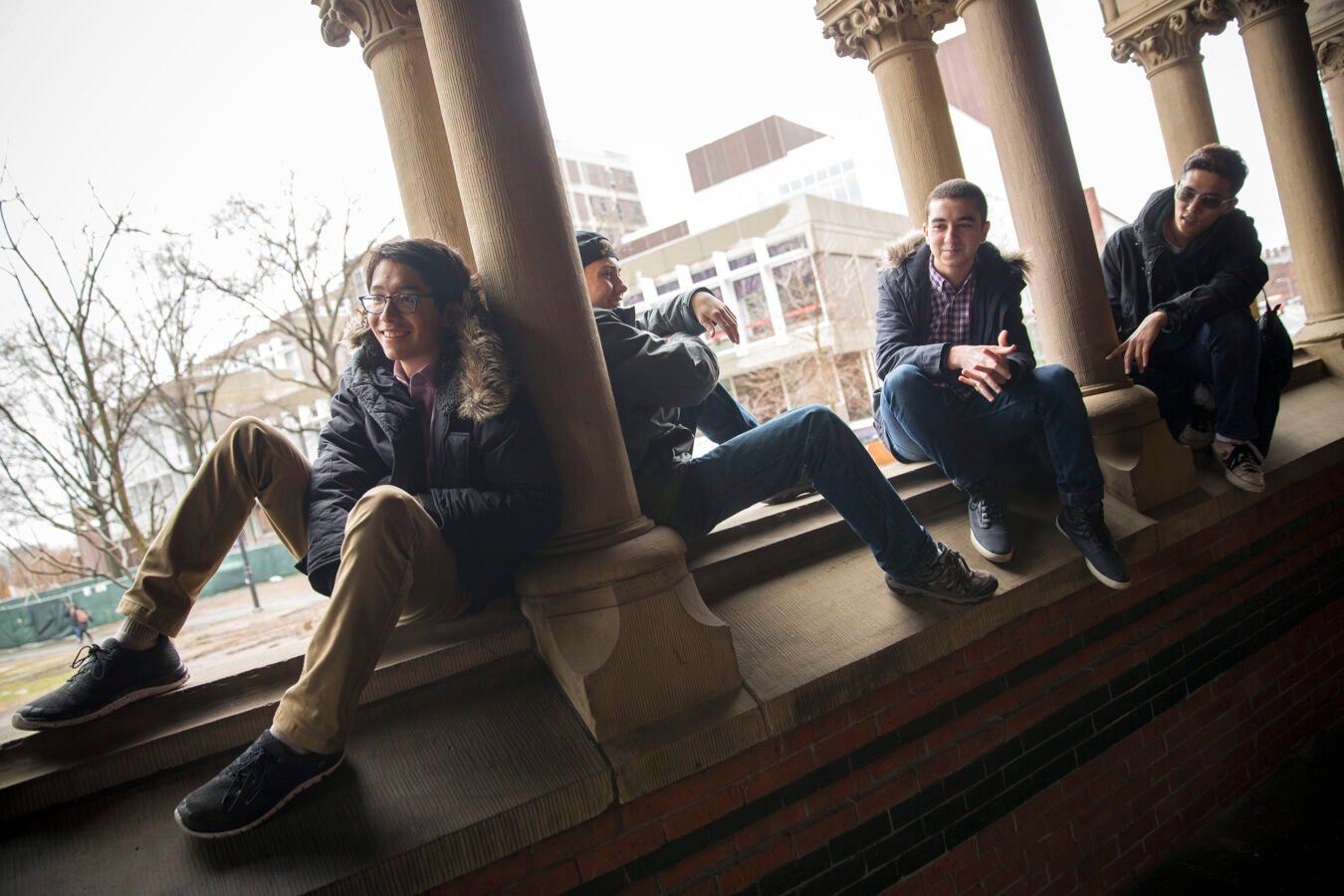 Roommates, Kenneth Shinozuka, (from left to right) and Clifford "Scotty" Courvoisier, Abdelrhman "Abdul" Saleh, Sung Ahn, All class of '20 who live in Holworthy Hall together, talk outside Annenberg Hall with the Science Center in the background.