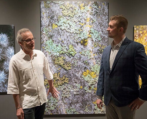 Roberto Kolter (left) and Scott Chimileski combine art and science in the photo exhibit “World in a Drop,” on view at the Museum of Natural History through Jan. 7.

