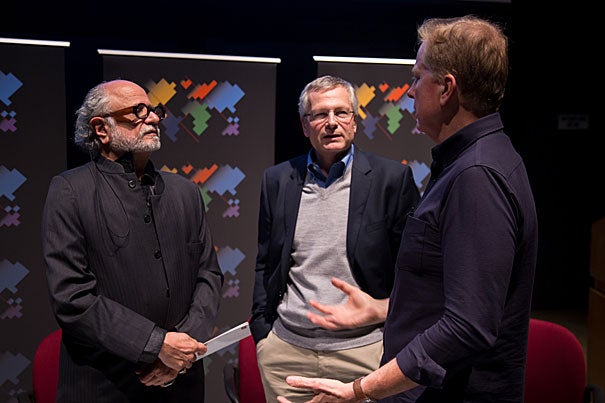 Tom Ashbrook (right), host of NPR's On Point, talks with Harvard professors Homi Bhabha (from left) and Dani Rodrik following a Worldwide Week forum on global citizenship and globalization.