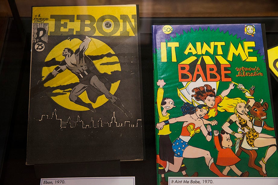 “Ebon,” the first African-American superhero title and “It Ain’t Me Babe,” the first underground comic written and drawn solely by women, both dated 1970. Jon Chase/Harvard Staff Photographer