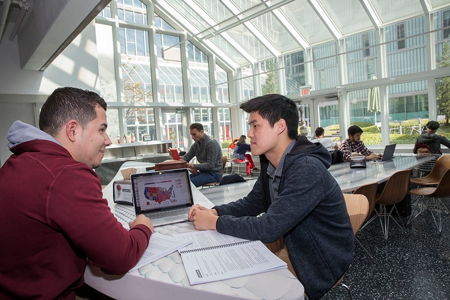 Jordan Silva '21 (left) and Dustin Chiang '19 study election results together. Kris Snibbe/Harvard Staff Photographer