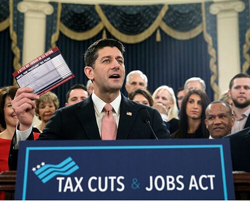 Speaker of the House Paul Ryan, R-Wis., with House Majority Whip Steve Scalise, R-La., far right, holds a proposed "postcard tax filing form" as they unveil the GOP's far-reaching tax overhaul, the first major revamp of the tax system in three decades, on Capitol Hill in Washington, Thursday, Nov. 2, 2017. 
