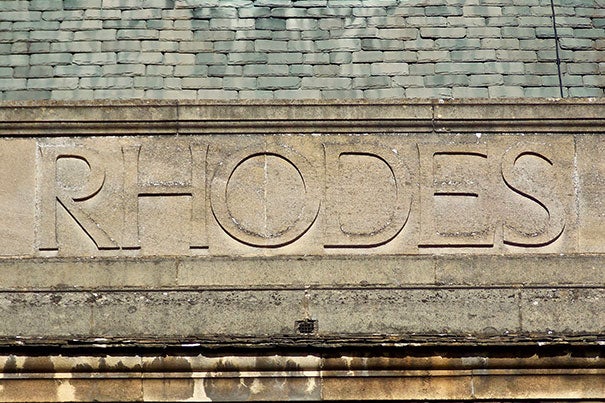 The photo of the embossed stone sign that reads Rhodes was taken at the back of the Rhodes House, the headquarters of the Rhodes Scholarships and the Rhodes Trust.